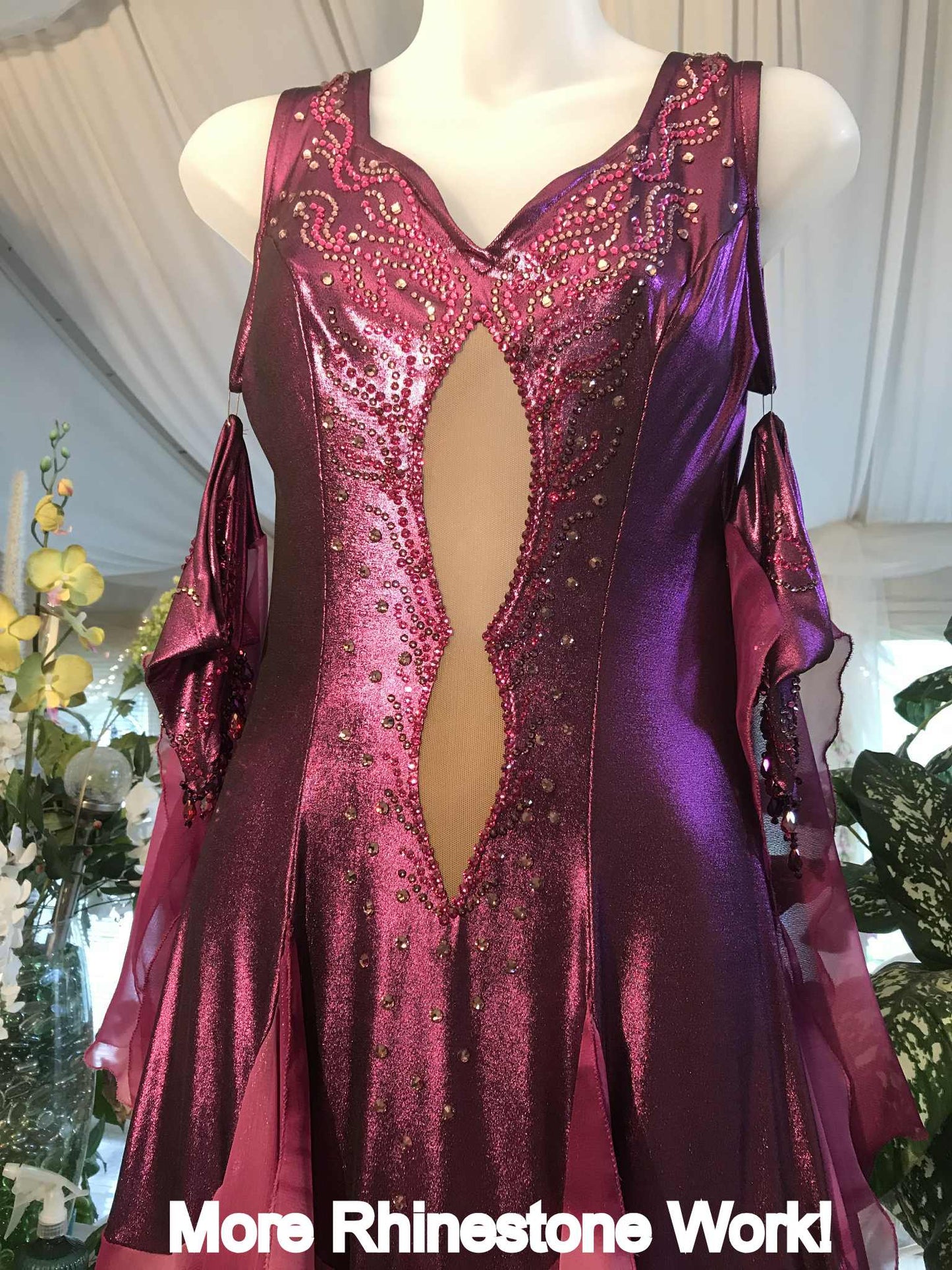 Top view of Crystal's Creations Purple/plum ballroom dress created of rich & luxurious plum metallic slinky ballroom dance dress with yards & yards of print chiffon… embellished with fuchsia Swarovski rhinestones… along with hand beading of bicone & teardrop Swarovski beads with added rhinestone work & back strap details