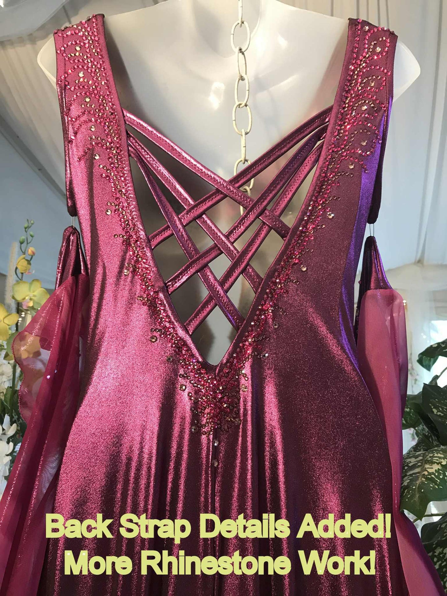Upper back view of Crystal's Creations Purple/plum ballroom dress created of rich & luxurious plum metallic slinky ballroom dance dress with yards & yards of print chiffon… embellished with fuchsia Swarovski rhinestones… along with hand beading of bicone & teardrop Swarovski beads with added rhinestone work & back strap details