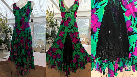 Tropical print rumba-bolero-tango dress of greens, magenta & fuchsia on a black background with lots of flounces & black lace inset in back skirt in progress