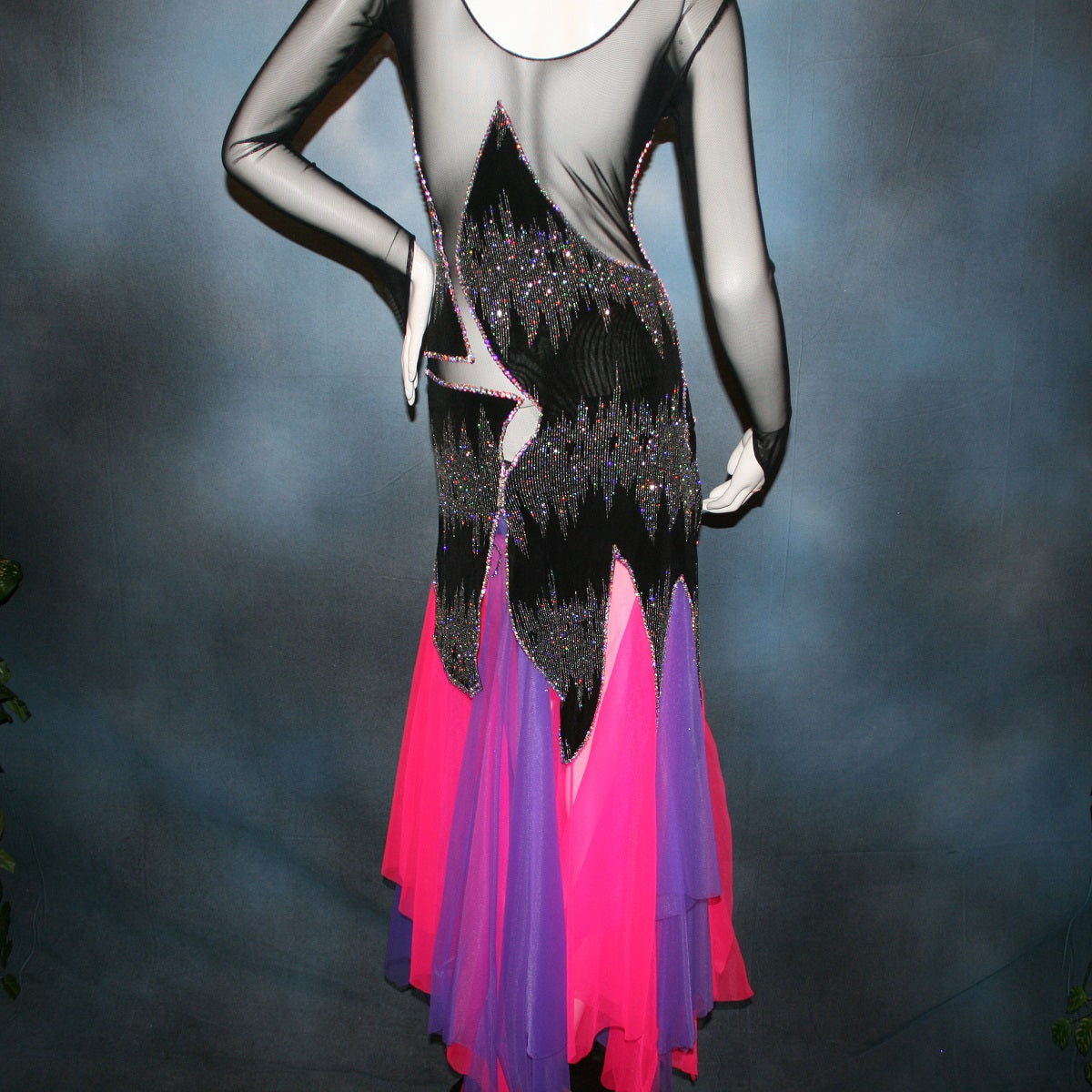 Back view of Crystal's Creations purple & pink underskirt with Latin/rhythm/converta ballroom dress created in black glitter slinky with an awesome electrifying Crystal AB glitter pattern artistically placed on a black stretch mesh base, embellished with Swarovski Crystal AB rhinestone work. It includes 3 skirts so you have 4 different looks for versatility.