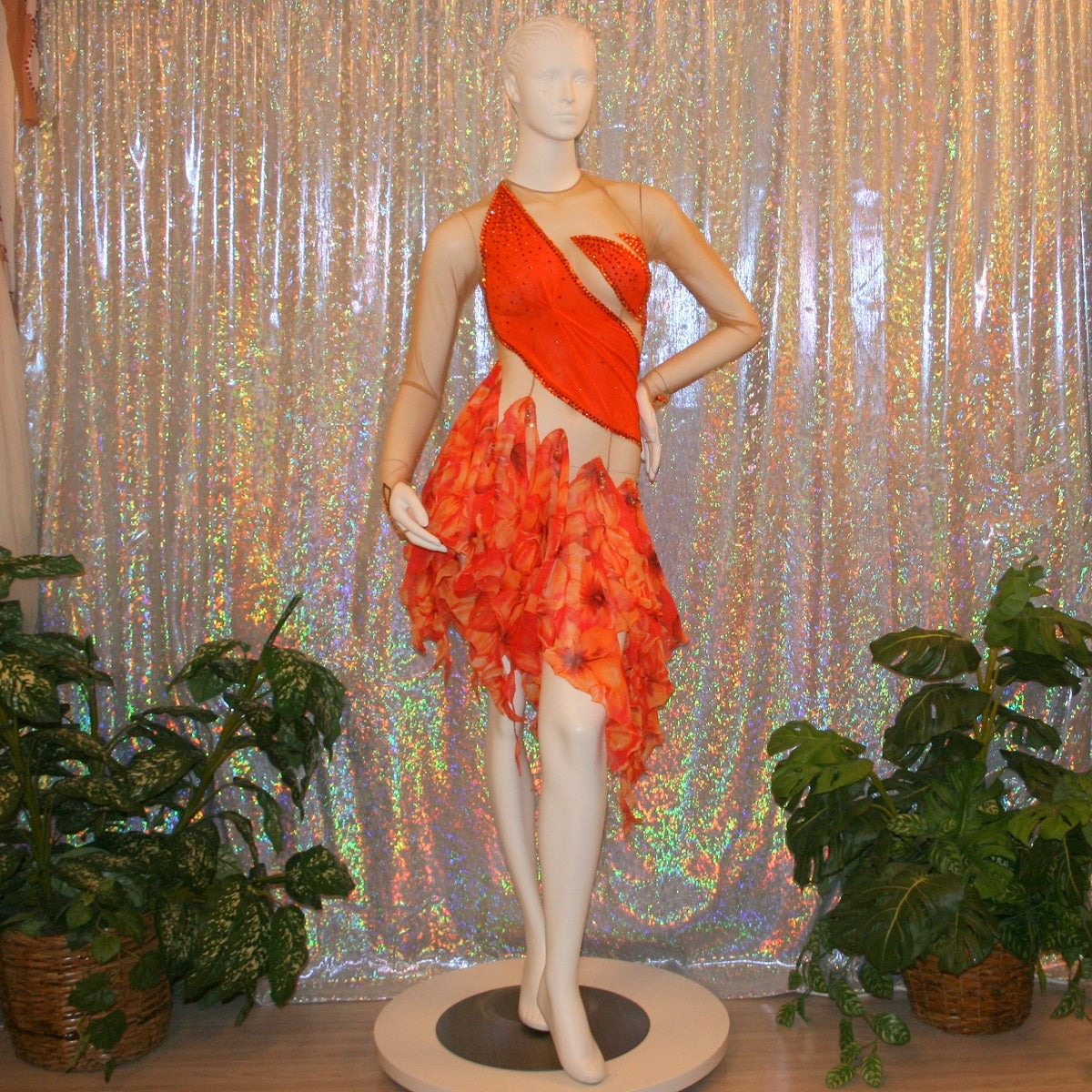 Orange Latin-rhythm dress created on a nude illusion base of luxurious orange solid slinky with orange tropical print chiffon skirting is embellished with orange & bronze Swarovski rhinestone work & hand beading.