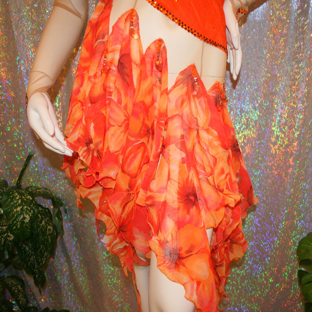 bottom view of Orange Latin-rhythm dress created on a nude illusion base of luxurious orange solid slinky with orange tropical print chiffon skirting is embellished with orange & bronze Swarovski rhinestone work & hand beading.