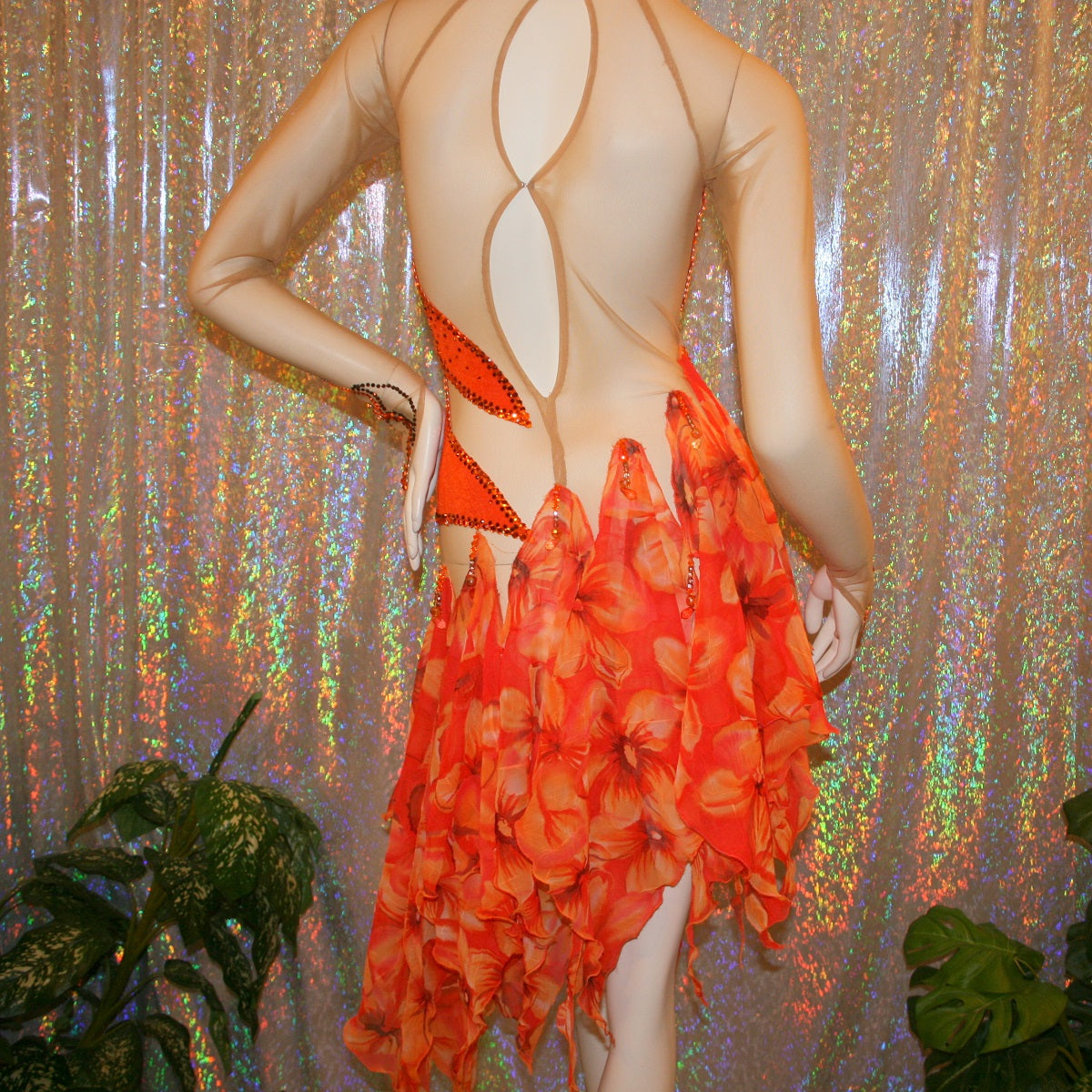 back view of Orange Latin-rhythm dress created on a nude illusion base of luxurious orange solid slinky with orange tropical print chiffon skirting is embellished with orange & bronze Swarovski rhinestone work & hand beading.