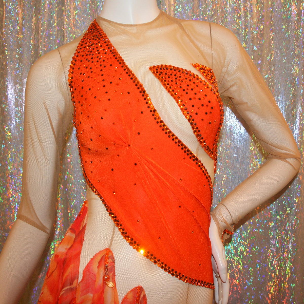 top view of Orange Latin-rhythm dress created on a nude illusion base of luxurious orange solid slinky with orange tropical print chiffon skirting is embellished with orange & bronze Swarovski rhinestone work & hand beading.