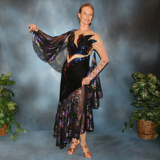 Black tango dress created of black luxurious solid slinky artistically patterned out on a nude illusion base, this dramatic dress design features hologram butterfly print flounces & floats. Crystal Meridian Blue Swarovski rhinestones embellish in detail to finish.