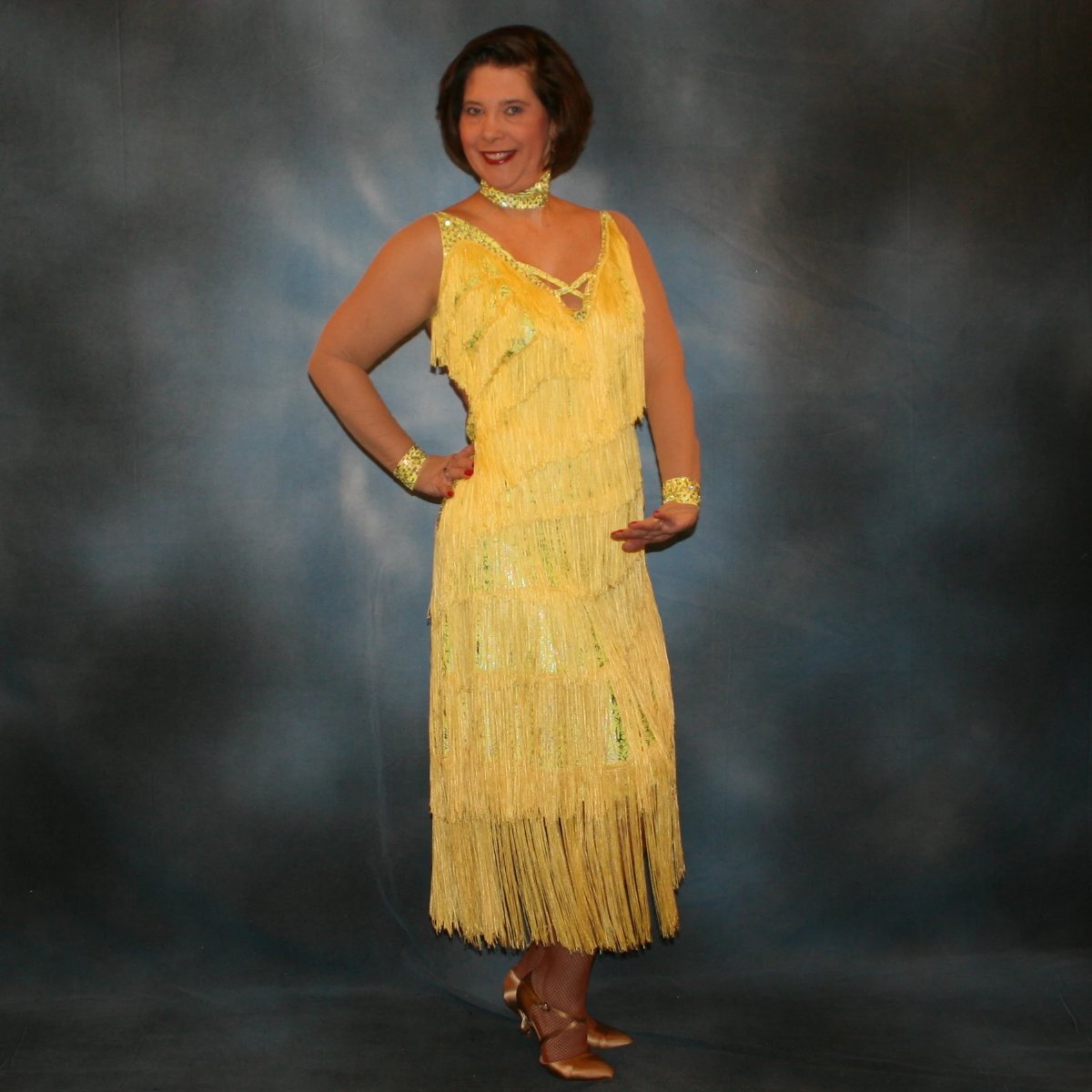 Crystal's Creations Yellow Latin/rhythm fringe dress created in yellow splash metallic lycra with yards of chainette fringe, sheer nude illusion sleeves, embellished with jonquil Swarovski rhinestones.