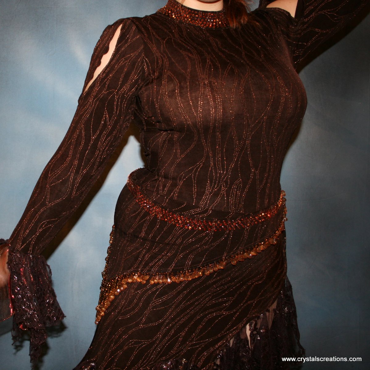 Crystal's Creations close up view of Brown tango dress, bolero dress or rumba dress created in chocolate brown & bronze glitter slinky with chocolate brown metallic lace & metallic tricot flounces is embellished with crystal copper Swarovski rhinestones at neckpiece & hipsash, which also has extensive hand beading.