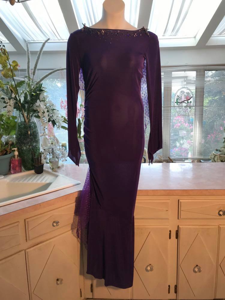 Crystal's Creations Purple Latin/rhythm/tango dress created of deep grape purple solid slinky with a touch of Swarovski rhinestone work done in metallic light gold & deep velvet purple, along with some hand beading & some gorgeous glittery floats.