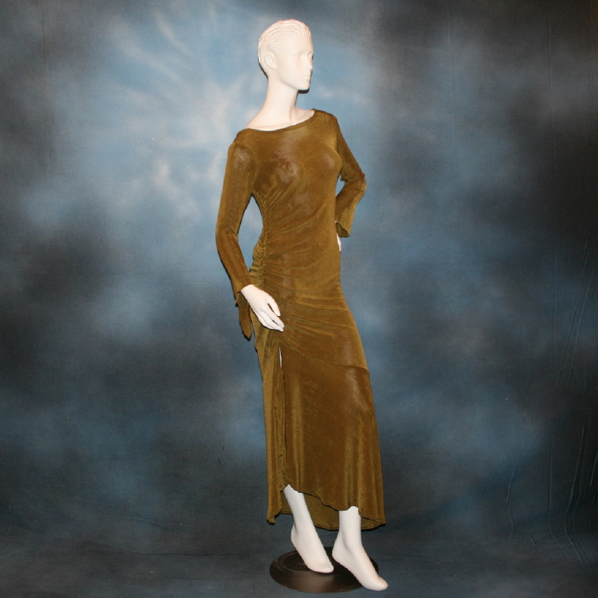 side view of Sage green Latin/rhythm/social dress created of luxurious sage green slinky features ruching up the right side & long sleeves with an open flared detail.