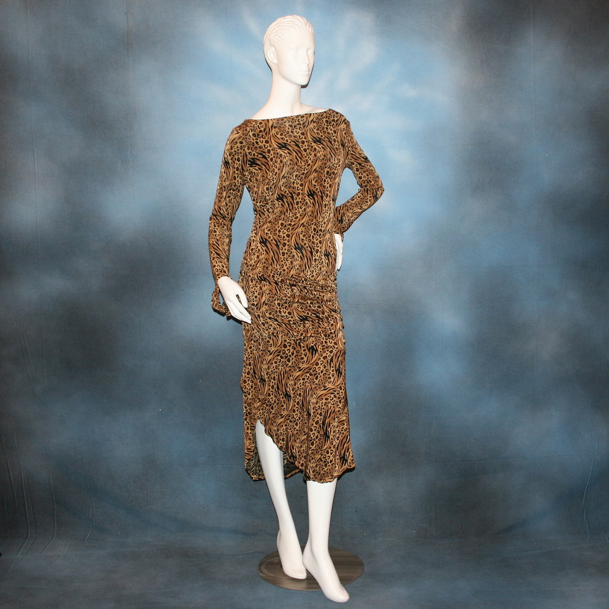 Latin/rhythm/tango dress created in serengeti print slinky with ruching, long flared sleeves, with Swarovski bead details on back.
