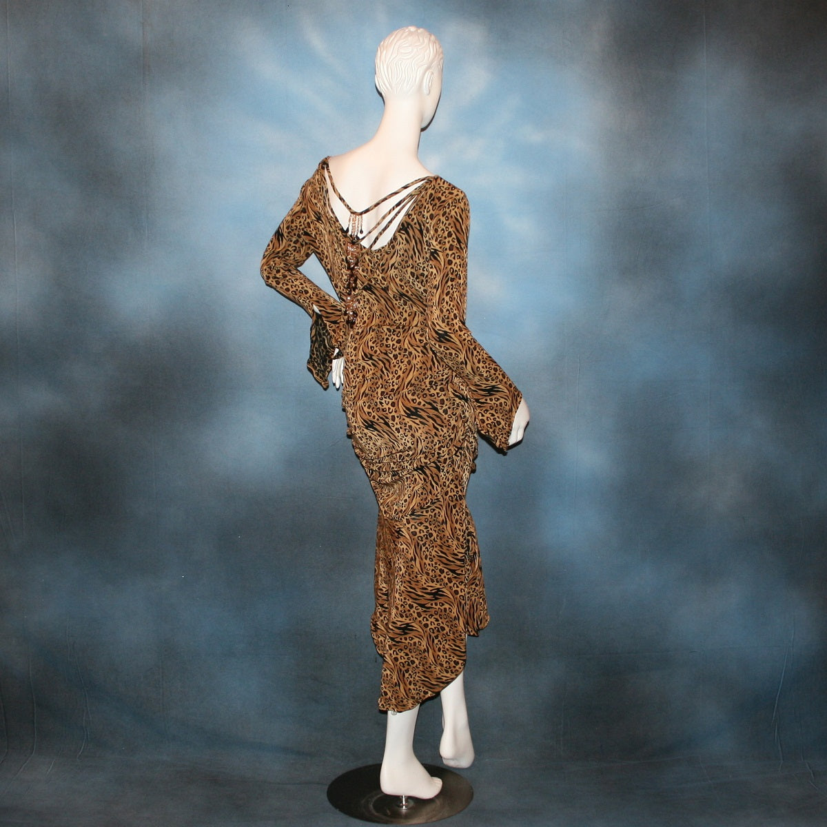 back view of Latin/rhythm/tango dress created in serengeti print slinky with ruching, long flared sleeves, with Swarovski bead details on back.