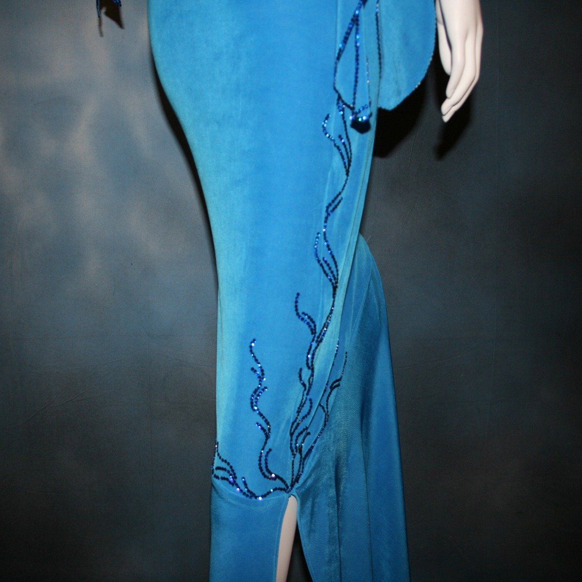 Crystal's Creations close up view of blue Latin/rhythm dress created of luxurious blue slinky, embellished with Swarovski detailed rhinestone work