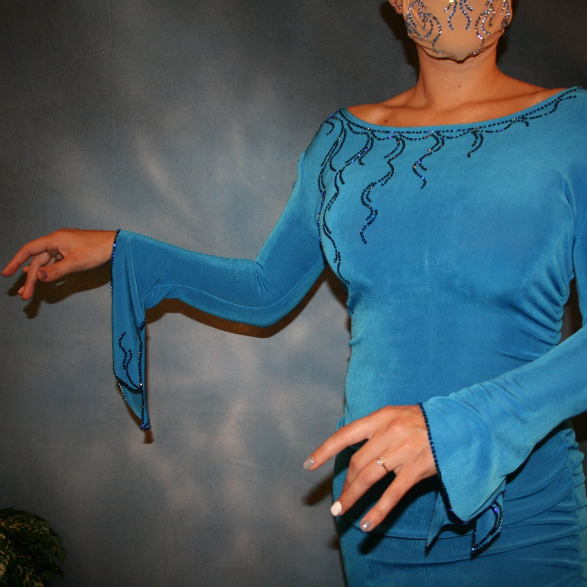 Crystal's Creations close up view of blue slinky Latin/rhythm dress with detailed blue Swarovski rhinestone work