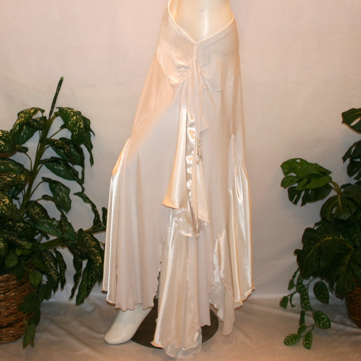 side view of White ballroom skirt is very full & created of luxurious white stretch velvet with white charmeuse insets & floats has a hip sash with Swarovski hand beaded accents.