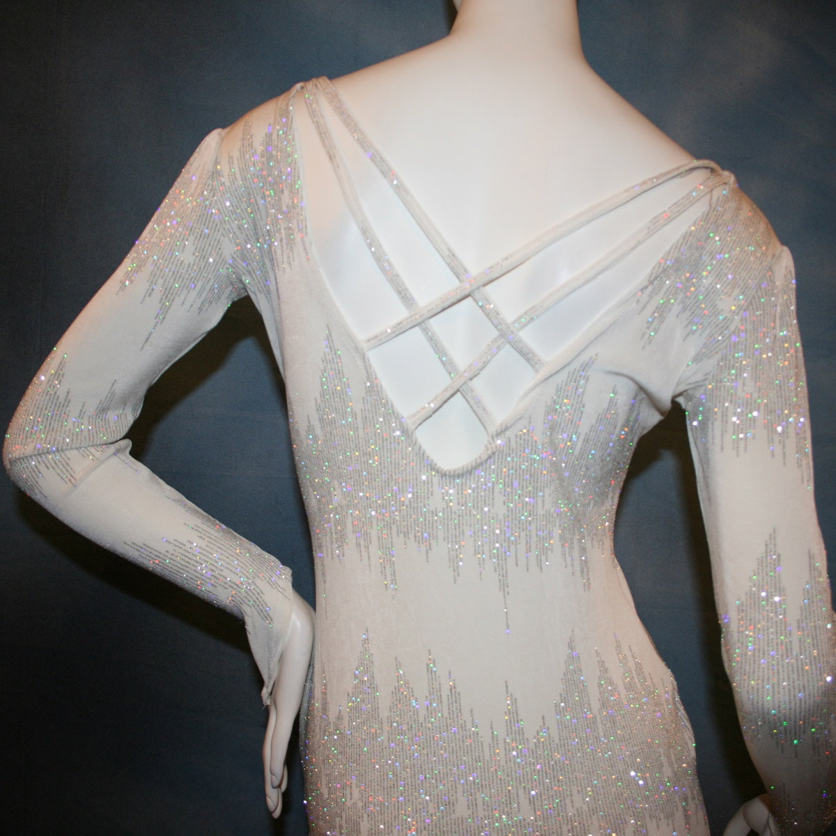 close up back view of White Latin/Rhythm dress created in glitter slinky with an awesome electrifying glitter pattern, features long sleeves, lattice strap details on back & a touch of Swarovski hand beading in the skirting.