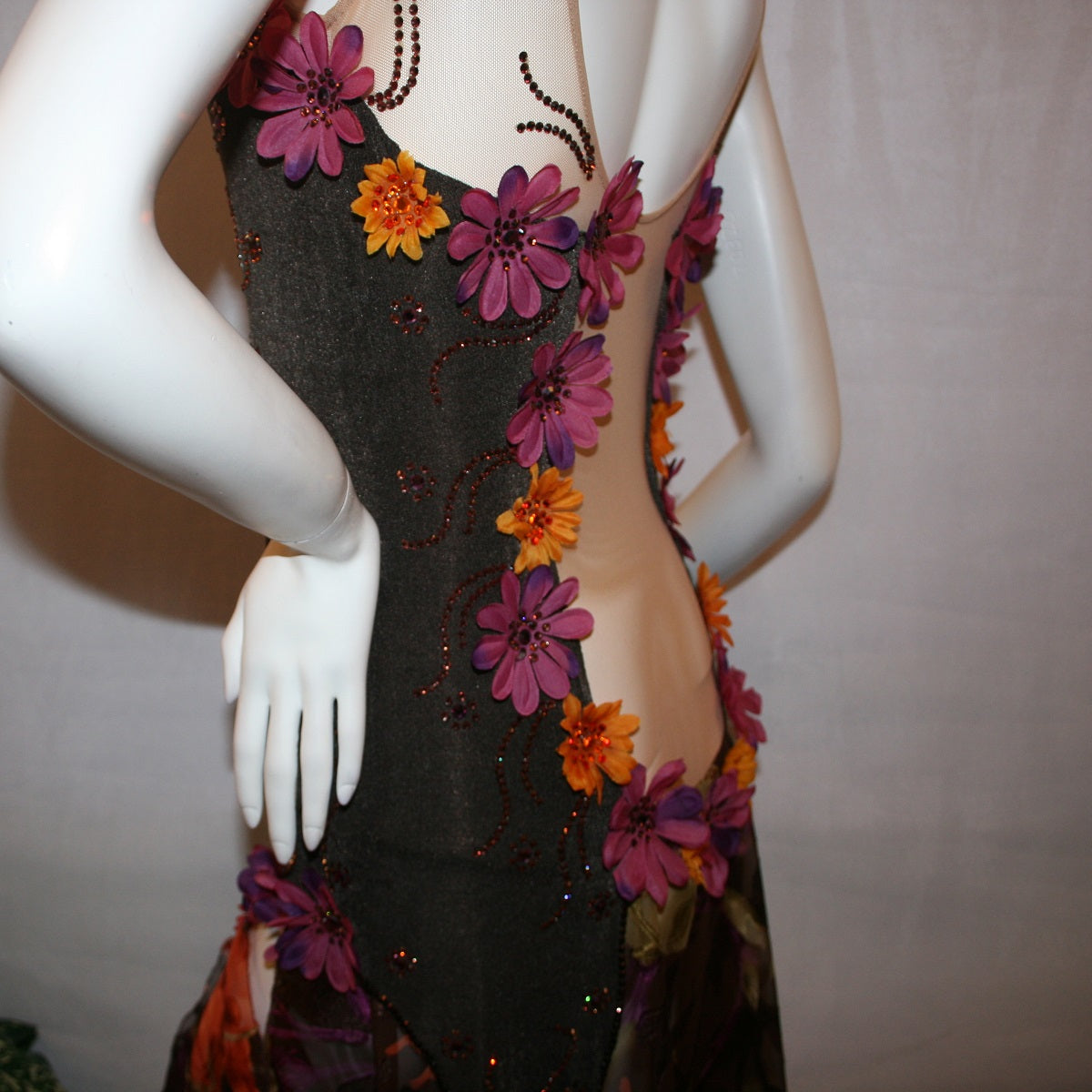 side view details of Brown converta ballroom dress created in deep chocolate brown slinky on a nude illusion base with panels of a gorgeous flowered chiffon with a sheen in browns, oranges, yellows, greens, burgundies & purples, with silk flower embellishments & Swarovski detailed rhinestone work.