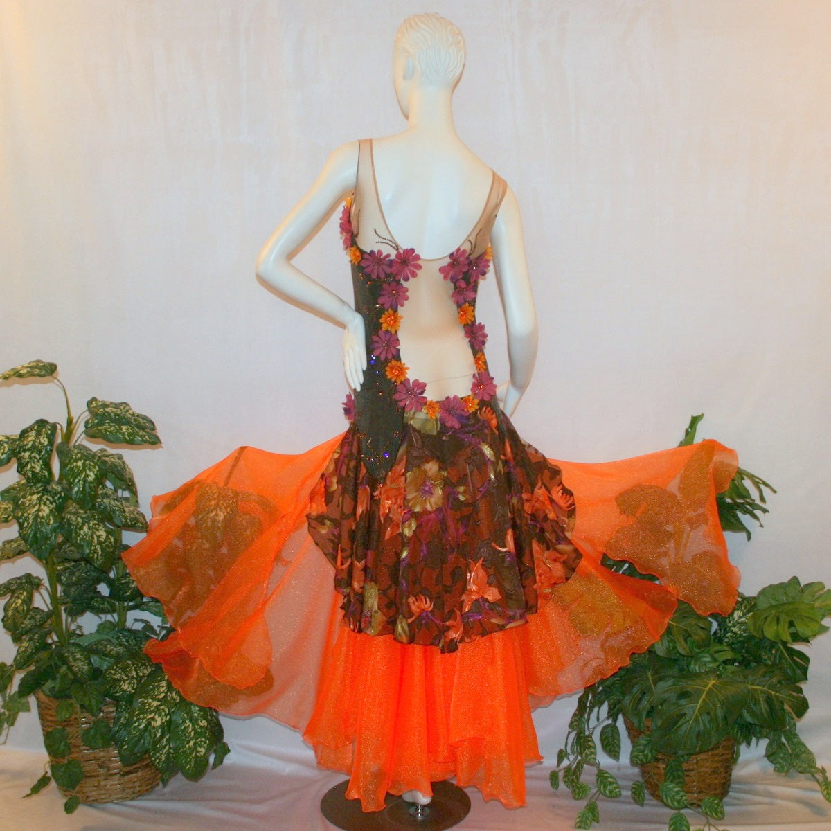 back view of Brown converta ballroom dress created in deep chocolate brown slinky on a nude illusion base with panels of a gorgeous flowered chiffon with a sheen in browns, oranges, yellows, greens, burgundies & purples, with silk flower embellishments & Swarovski detailed rhinestone work.