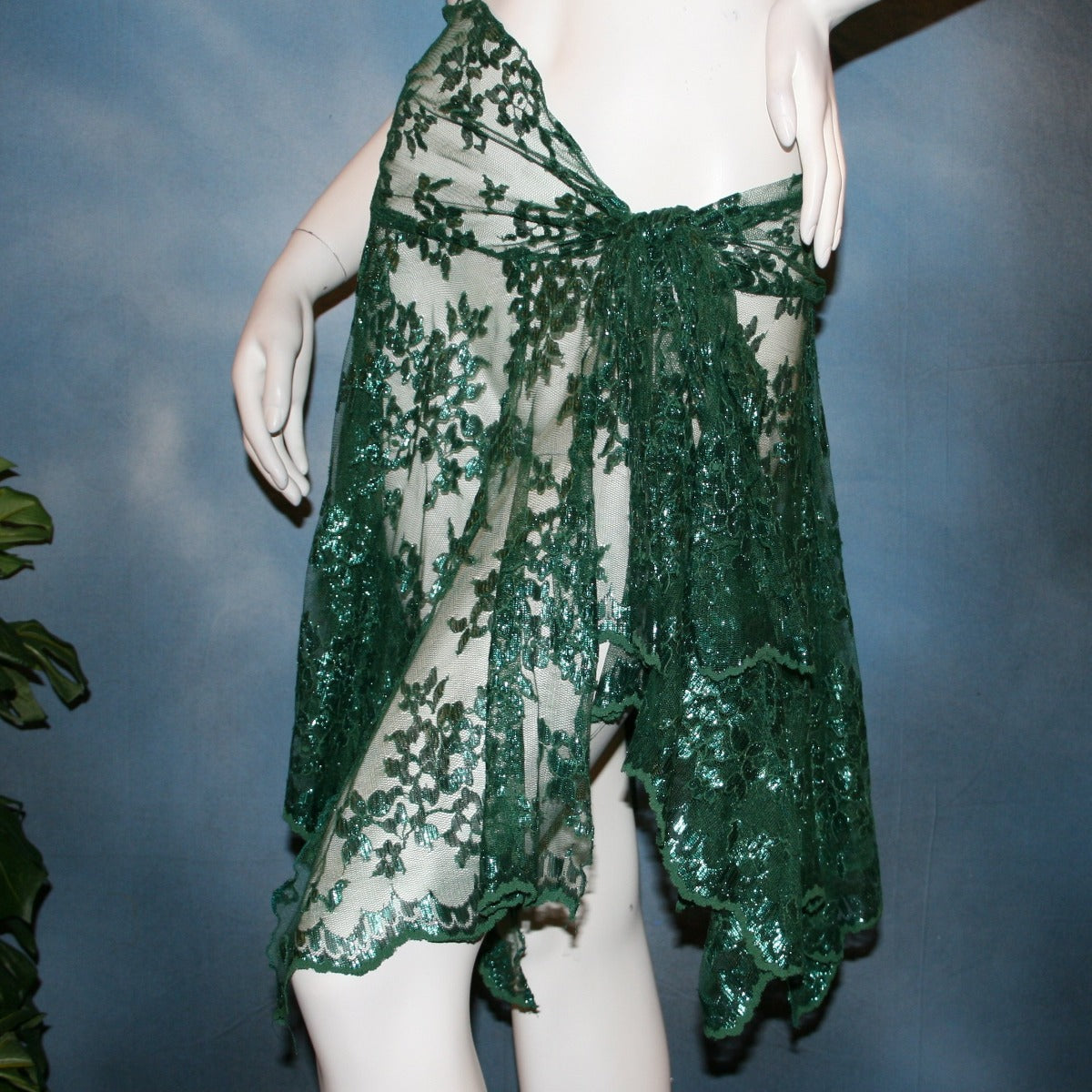 close front view of Green lace short Latin/rhythm skirt, wrap style, was created with green metallic lace.