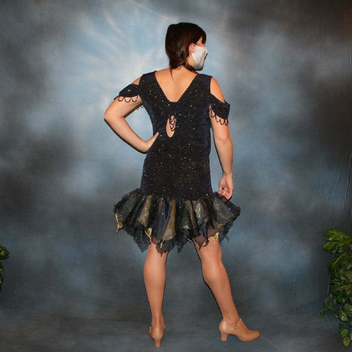 Back view of Crystal's Creations Navy Latin/rhythm/social dance dress created in navy glitter slinky fabric with oodles of glitter organza flounces of navy & soft yellow, with hand beading at sleeve edges & back peek-a-boo. A great social ballroom dress for any special occasion, as well as a Latin/rhythm dance dress