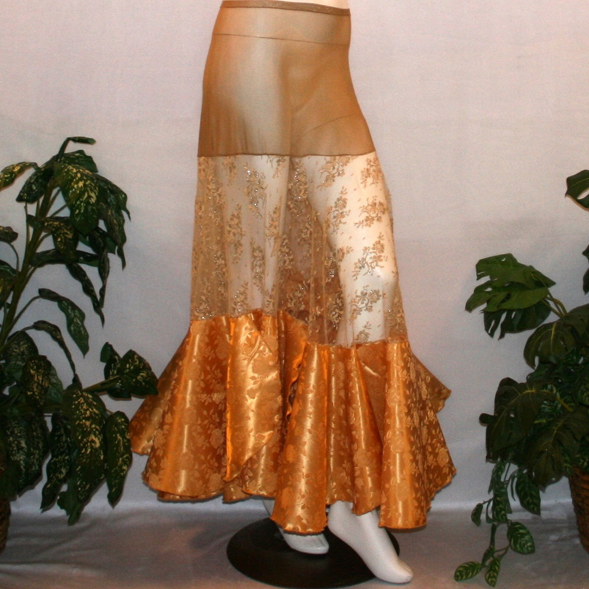 Ballroom skirt created on a nude illusion hip base of a gorgeous & delicate gold lace top flared section with gold brocade flounces at the bottom.