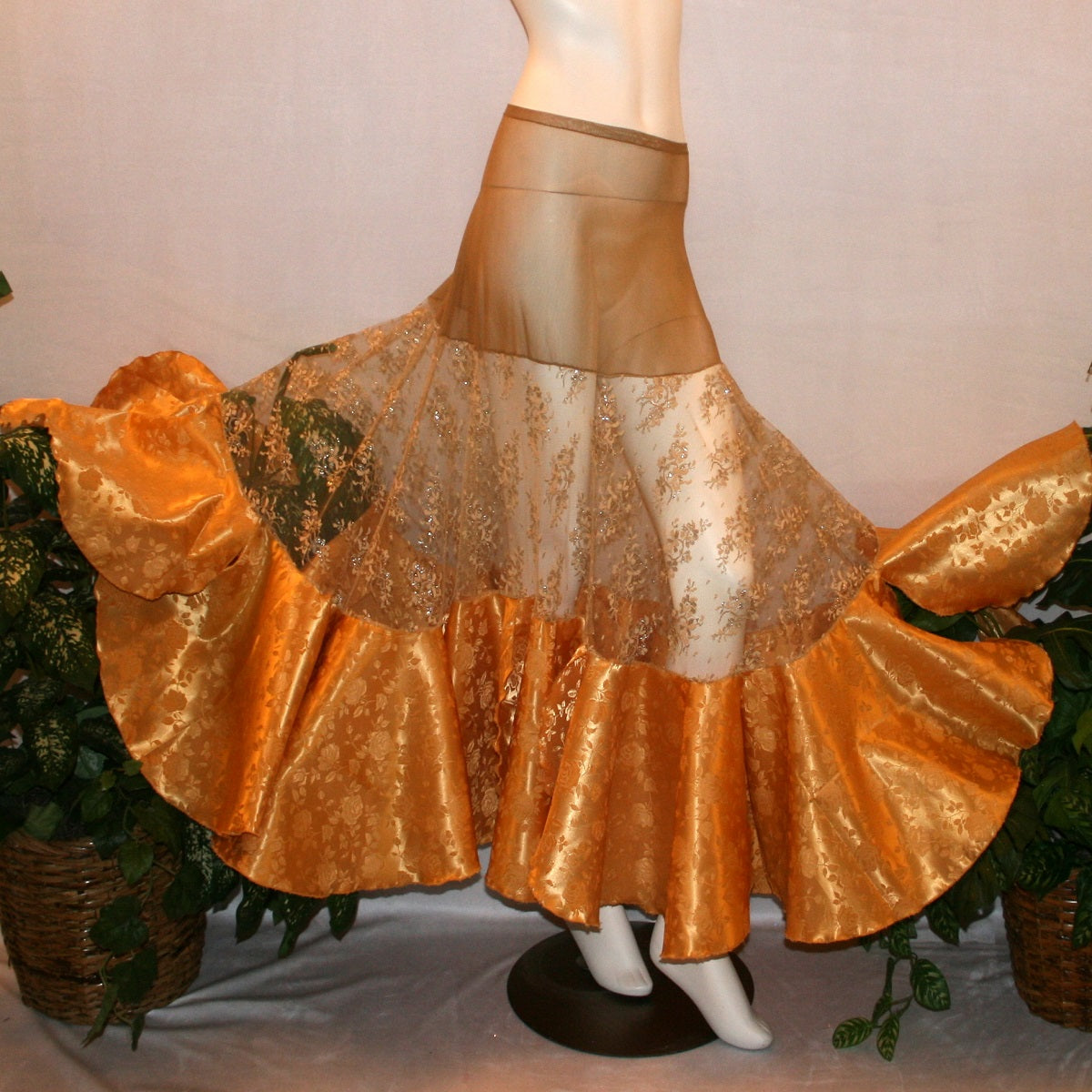 Ballroom skirt created on a nude illusion hip base of a gorgeous & delicate gold lace top flared section with gold brocade flounces at the bottom.