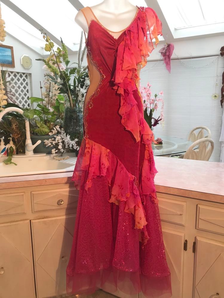Gorgeous rose colored converta ballroom dance dress was created on a nude illusion base of rose colored slinky with flounces of a gorgeous oriental flower print crinkle chiffon of pinks, yellows & oranges. Detailed Swarovski rhinestone work which ties in so beautifully with with the print chiffon, is done in pinks, yellows & orange.