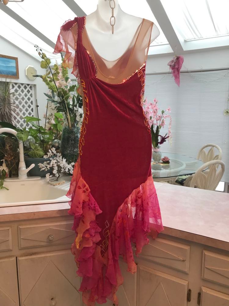 back view of Latin/rhythm dress portion of Gorgeous rose colored converta ballroom dance dress was created on a nude illusion base of rose colored slinky with flounces of a gorgeous oriental flower print crinkle chiffon of pinks, yellows & oranges. Detailed Swarovski rhinestone work which ties in so beautifully with with the print chiffon, is done in pinks, yellows & orange.