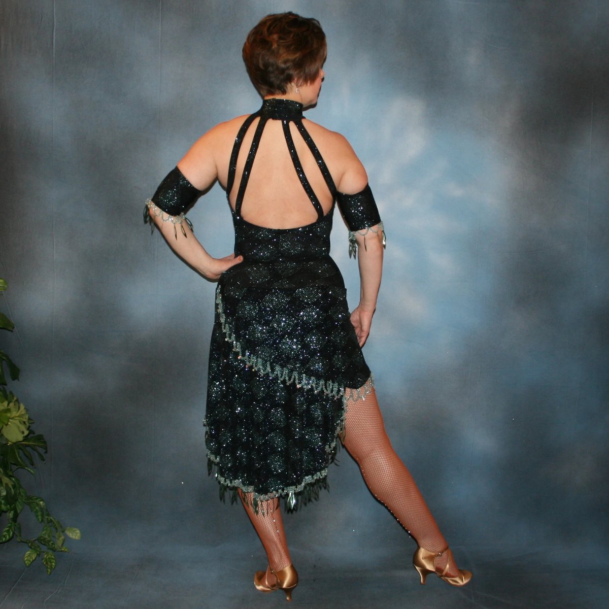 back view of Black & blue lavish Latin/rhythm dance dress created in slinky glitterknit black & blue harlequin pattern featuring nude illusion cutouts, extensive light blue hand beading with spangles & Swarovski rhinestone work.