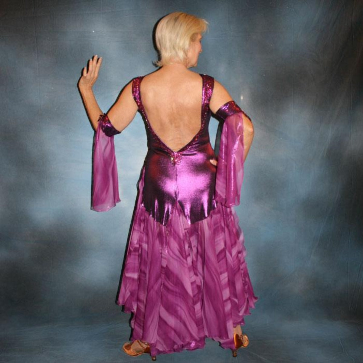 Crystal's Creations back view of Purple/plum ballroom dress created of rich & luxurious plum metallic slinky ballroom dance dress with yards & yards of print chiffon… embellished with fuchsia Swarovski rhinestones… along with hand beading of bicone & teardrop Swarovski beads