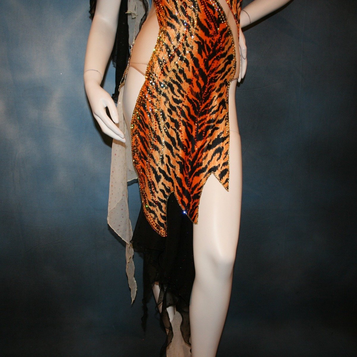 Crystal's Creations close up bottom view of orange & black tiger print Latin/rhythm dress with pale yellow accents