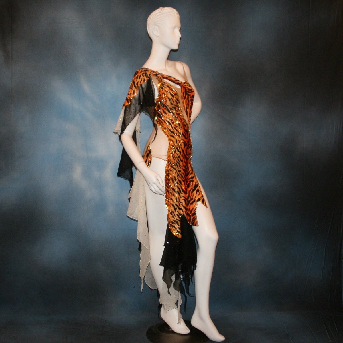 Crystal's Creations close up bottom view of orange & black tiger print Latin/rhythm dress with pale yellow accents