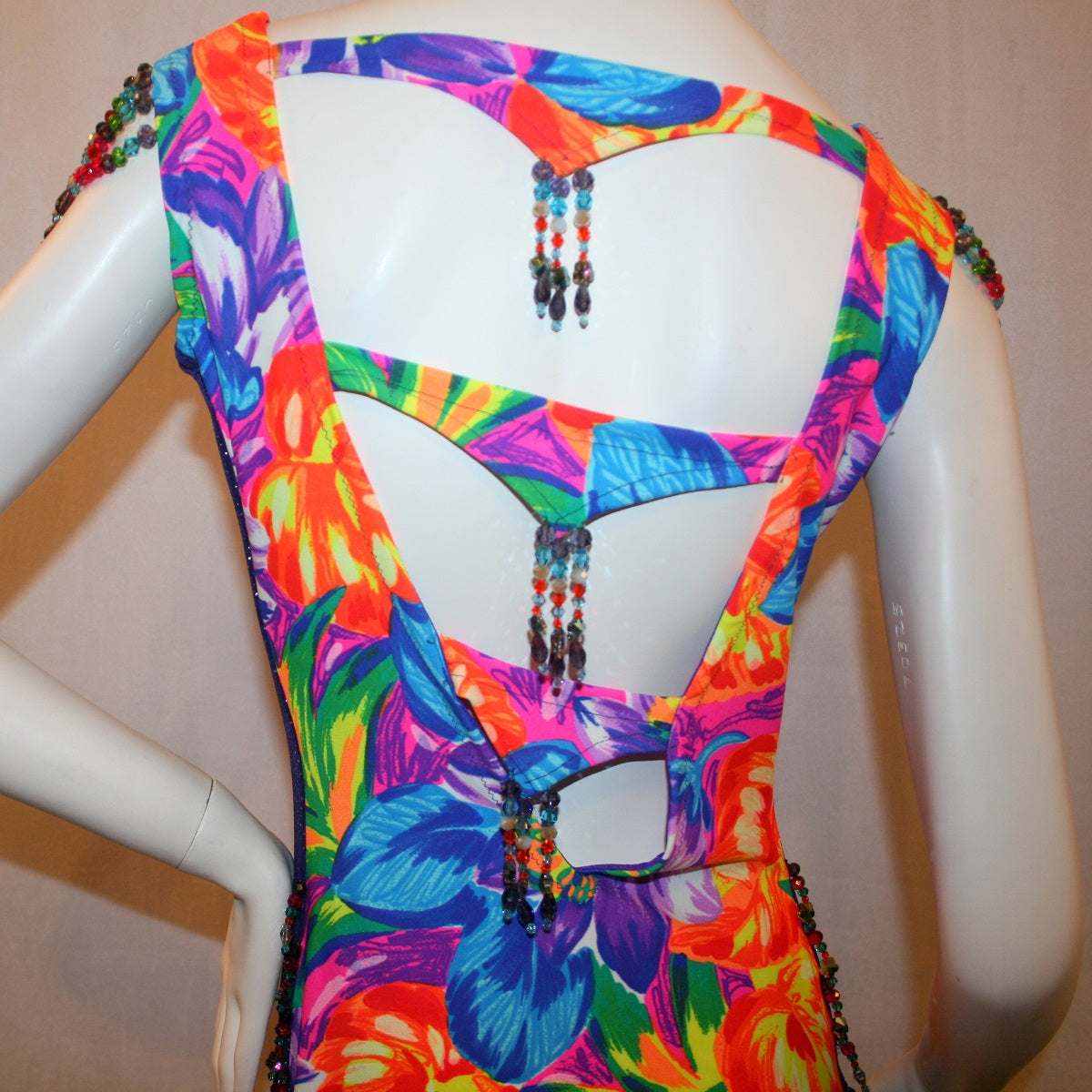 upper back view of Tropical print Latin-rhythm dress created in tropical print lycra with side color blocking in deep purple glitter slinky with lots or flounces, back detailing, embellishing with Swarovski hand beading.