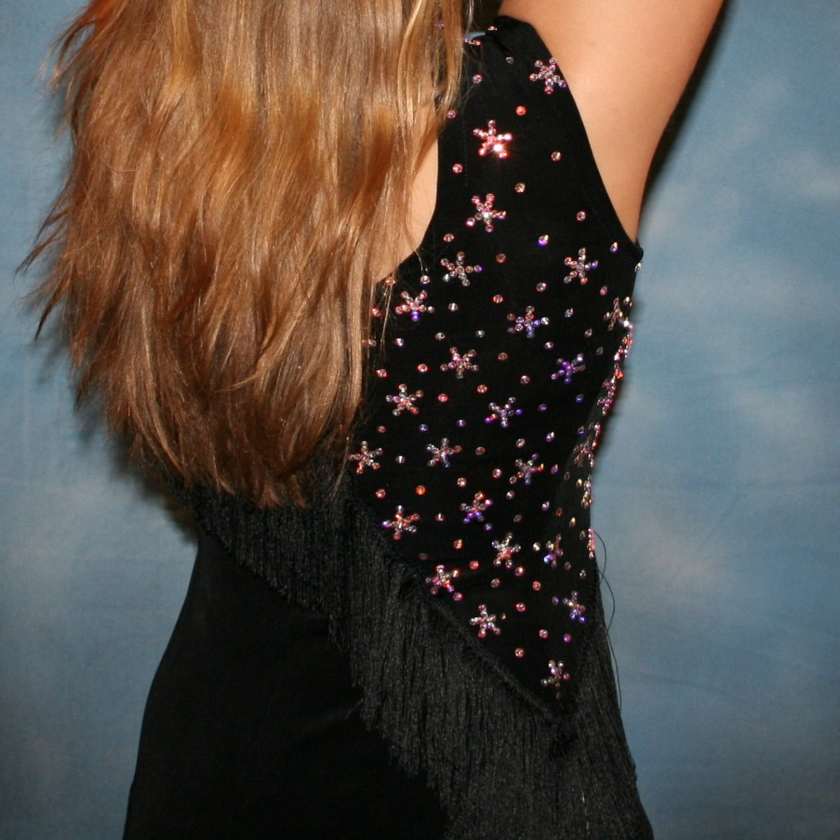 Crystal's Creations close up back view of Black Latin/rhythm dress with fringe created in luxurious black solid slinky with silky black chainette fringe, wristbands, matching choker, embellished with CAB Swarovski rhinestones, about 7 gross.