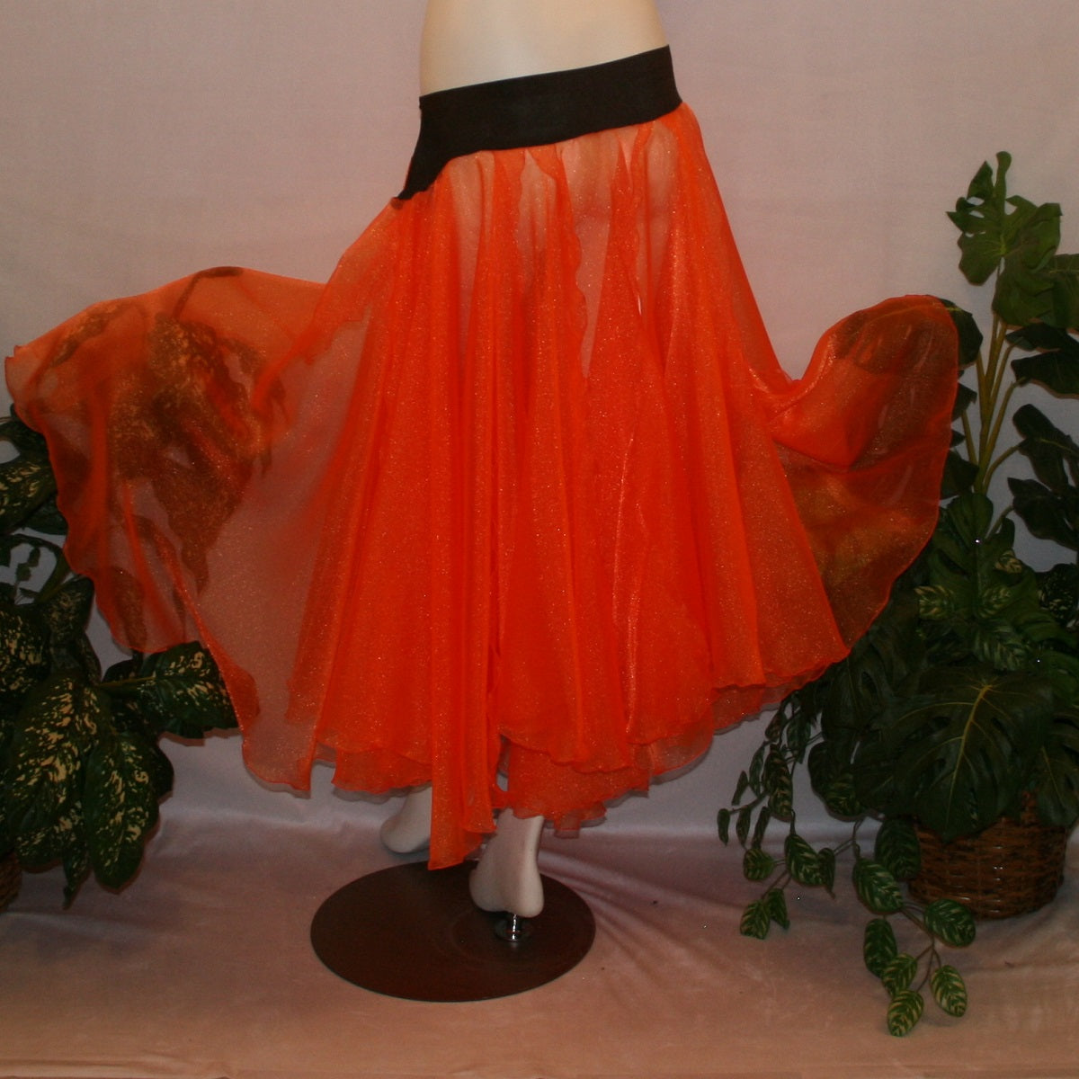 back view of Orange ballroom skirt in yards of large petal shape panels of orange organza with a brown waistband to pair with one of our Fall Flowers dresses to create a converta ballroom dress. The skirt can be custom made in many other colors.