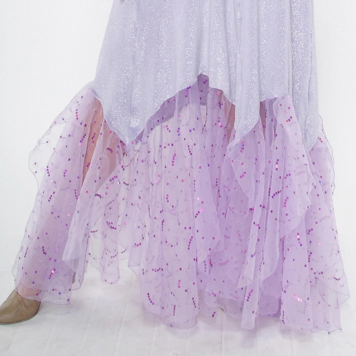 Crystal's Creations lower view of Luxurious orchid ballroom dress was created in glitter velvet on nude illusion base, flairs out to sheer organza with sequined skirting. embellished with fuschia & CAB Swarovski rhinestone work.