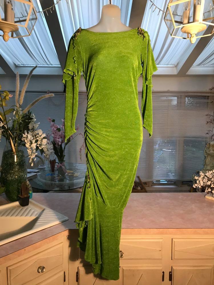 Apple green social Latin/rhythm dress was created of apple green glitter slinky, features ruching on the right side, long sleeves, scoop back, & full skirting with open side that has Swarovski hand beaded detail