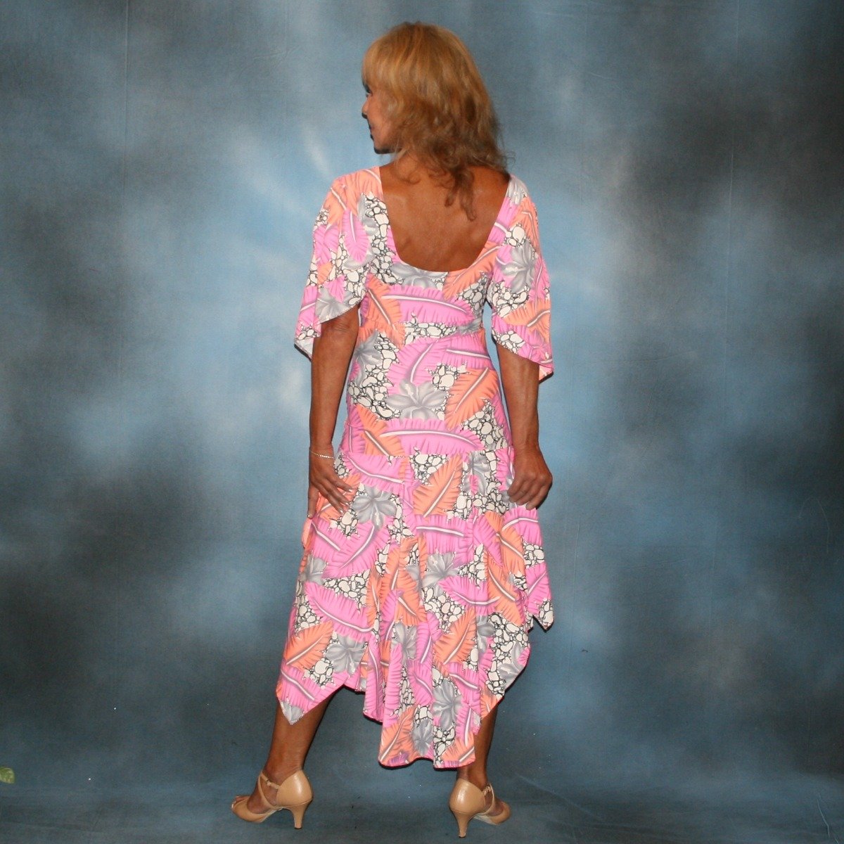 back view of Pink tropical print lycra dress created of pink, orange, white & black tropical print lycra with full flare sleeves & full circle skirt, with a bodysuit base, so a great dress for Latin/rhythm dance practice ballroom teacher dress, especially if you work on drops & lifts!