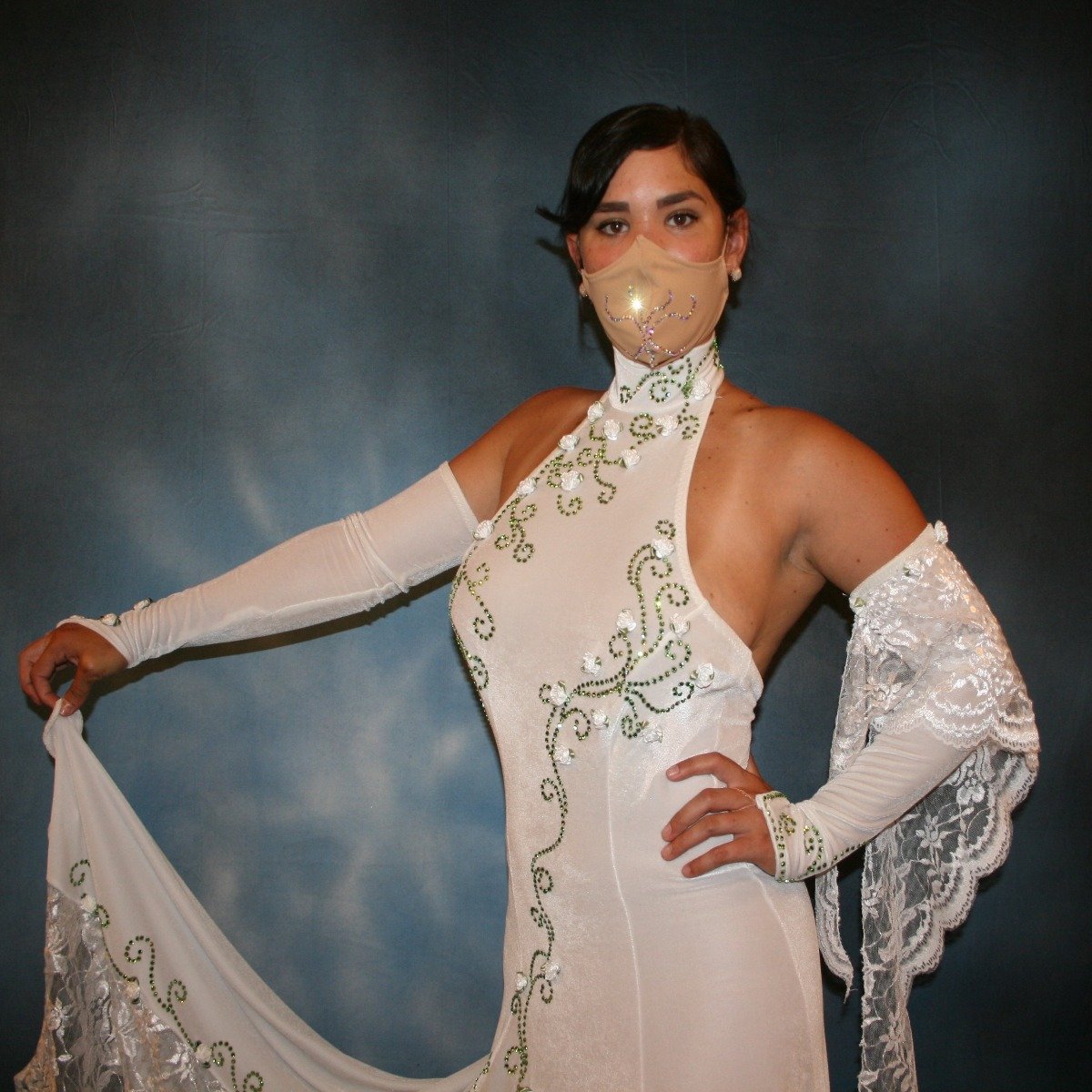 Crystal's Creations close up of White ballroom dance dress was created in luxurious white stretch velvet with sequined lace insets & arm float, embellished with green peridot Swarovski detailed rhinestone work & miniature silk roses