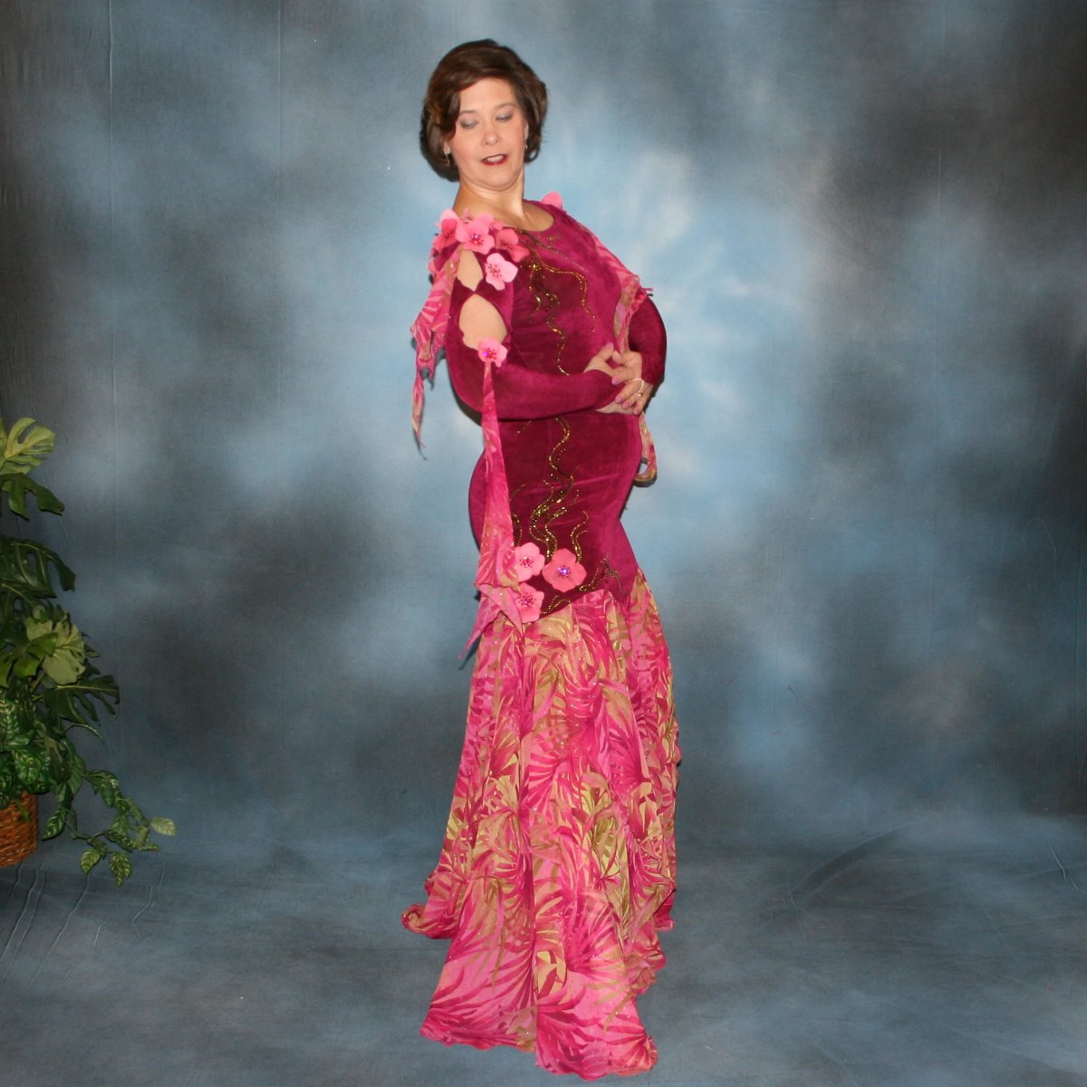 Crystal's Creations side view of Cranberry ballroom dress, created in luxurious cranberry solid slinky with yards of exotic print of cranberries, pinks & touch of greens. Embellishments of Swarovski adorned silk flowers plus detailed Swarovski rhinestone work