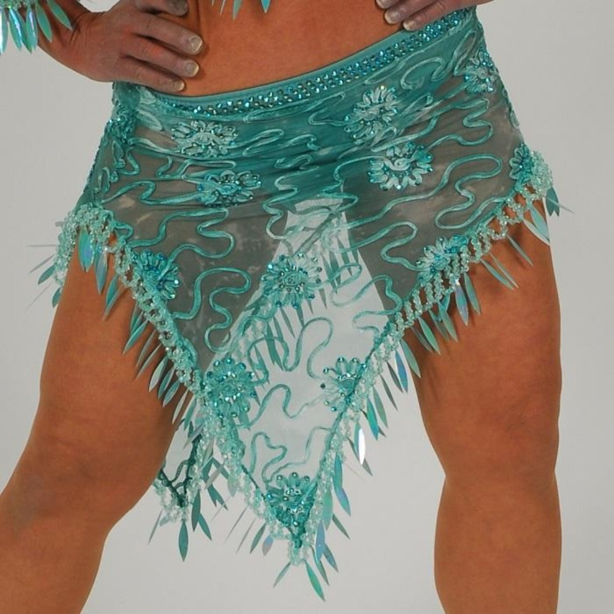 Crystal's Creations close up bottom view ofGorgeous aqua Latin/rhythm two piece dance dress created of gorgeous aqua soutache lace fabric, embellished with about 10 gross of Aqua AB Swarovski stones with lots of hand beading & paillettes.
