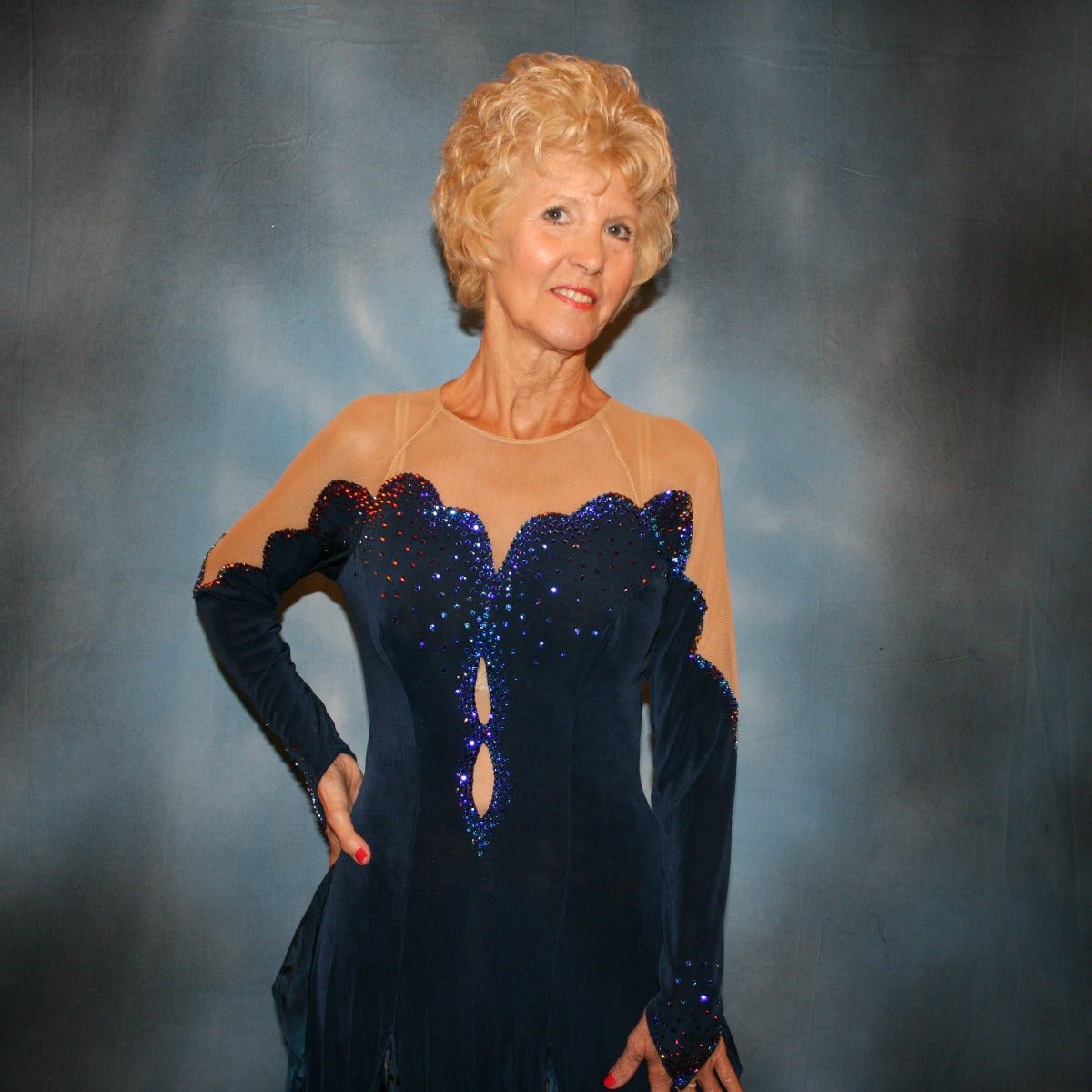 Crystal's Creations close up view of Navy blue Latin/rhythm dress was created in luxurious navy blue solid slinky, featuring flounce/tails of specialty fabric in shades of navy & blues, is embellished with meridian blue Swarovski rhinestones, with built in nude illusion body contouring bodysuit base.