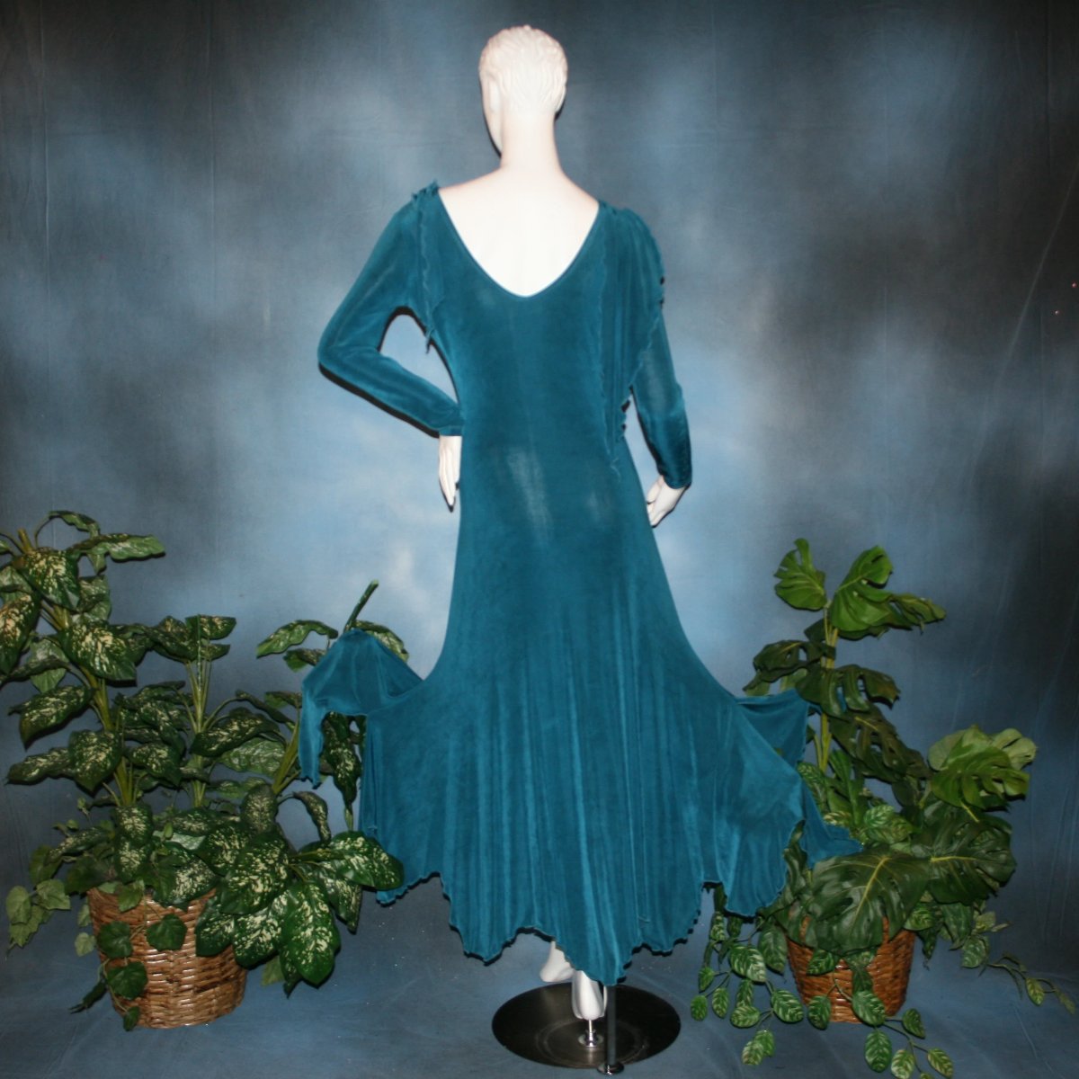back view of Blue social ballroom dress created in deep blue luxurious solid slinky fabric with attached draping on shoulders & scalloped skirt edge. Very full around bottom & can be a beginner ballroom dancer smooth dress.