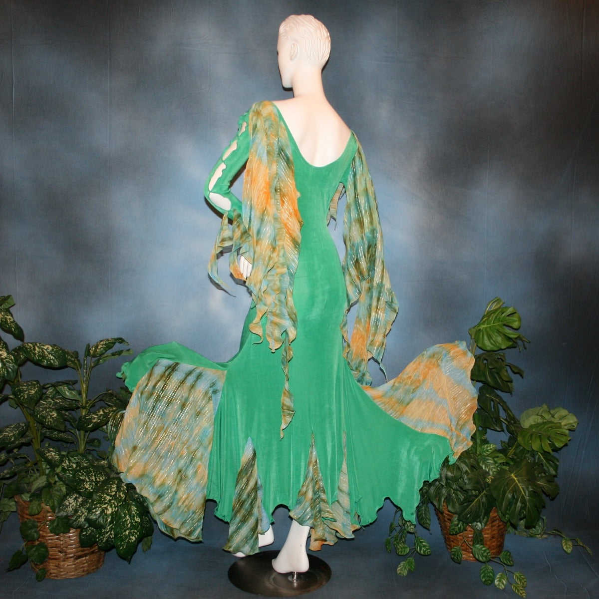 Crystal's Creations back view of Gorgeous green ballroom dress created in luxurious solid slinky fabric with printed chiffon of greens, with gold accents insets. Very full around bottom...can be a beginner ballroom dancer smooth or standard dress.