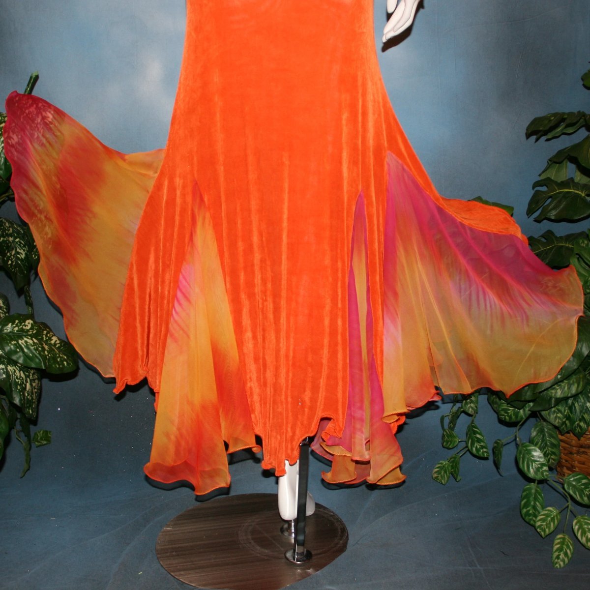 lower close view of Orange social ballroom dress created in luxurious solid slinky fabric with chiffon insets of rainbow oranges & yellows, with hand beading on arm draping. Very full around bottom, and makes a great beginner ballroom dancer smooth dress.