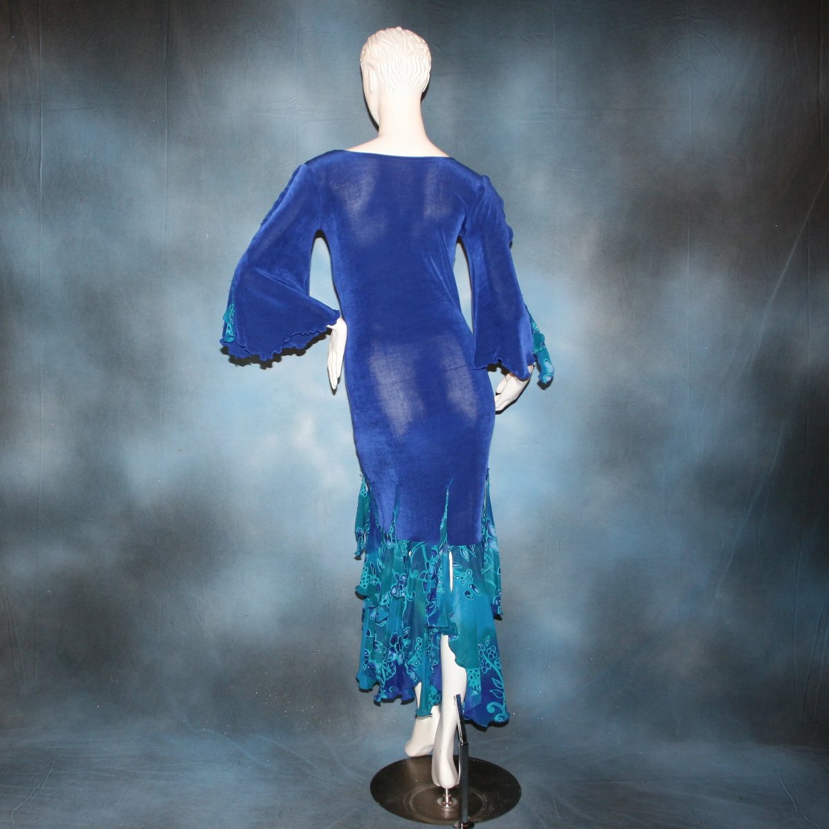 Crystal's Creations back view of Royal blue Latin/rhythm style social ballroom dress was created in luxurious & rich deep royal blue solid slinky fabric with tropical print flounces in shades of royal blues & turquoise….only one of exact print.  A great social dress for any special occasion, as well as a great beginner show dress!
