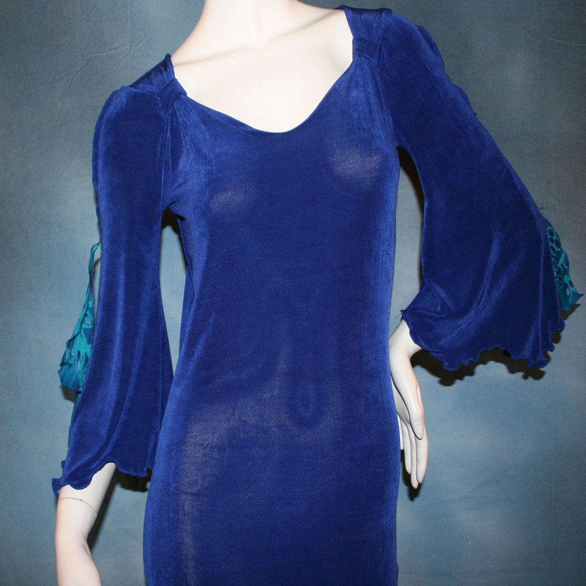 close up view of Royal blue Latin/rhythm style social ballroom dress was created in luxurious & rich deep royal blue solid slinky fabric with tropical print flounces in shades of royal blues & turquoise….only one of exact print.  A great social dress for any special occasion, as well as a great beginner show dress!