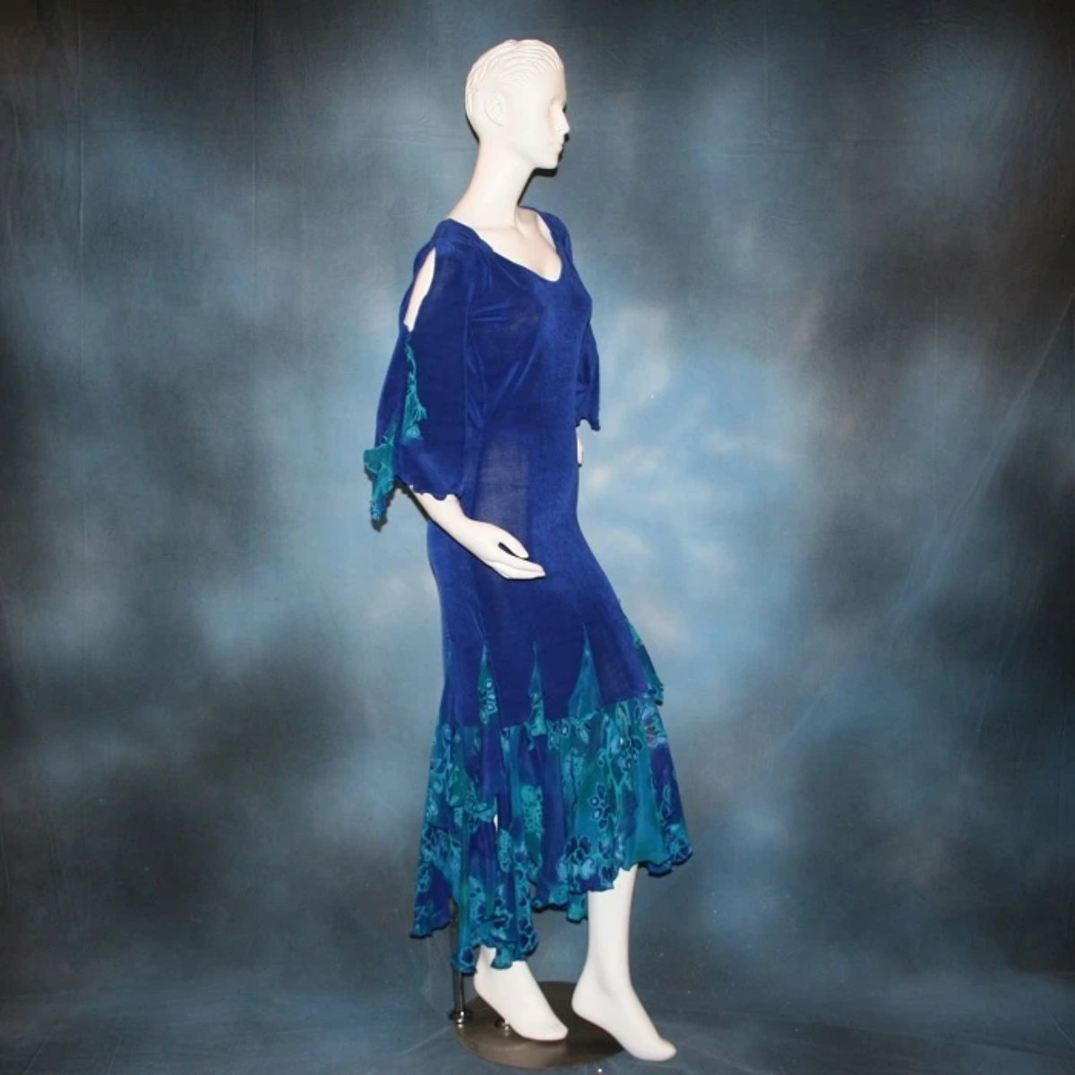 Crystal's Creations side view of Royal blue Latin/rhythm style social ballroom dress was created in luxurious & rich deep royal blue solid slinky fabric with tropical print flounces in shades of royal blues & turquoise….only one of exact print.  A great social dress for any special occasion, as well as a great beginner show dress!