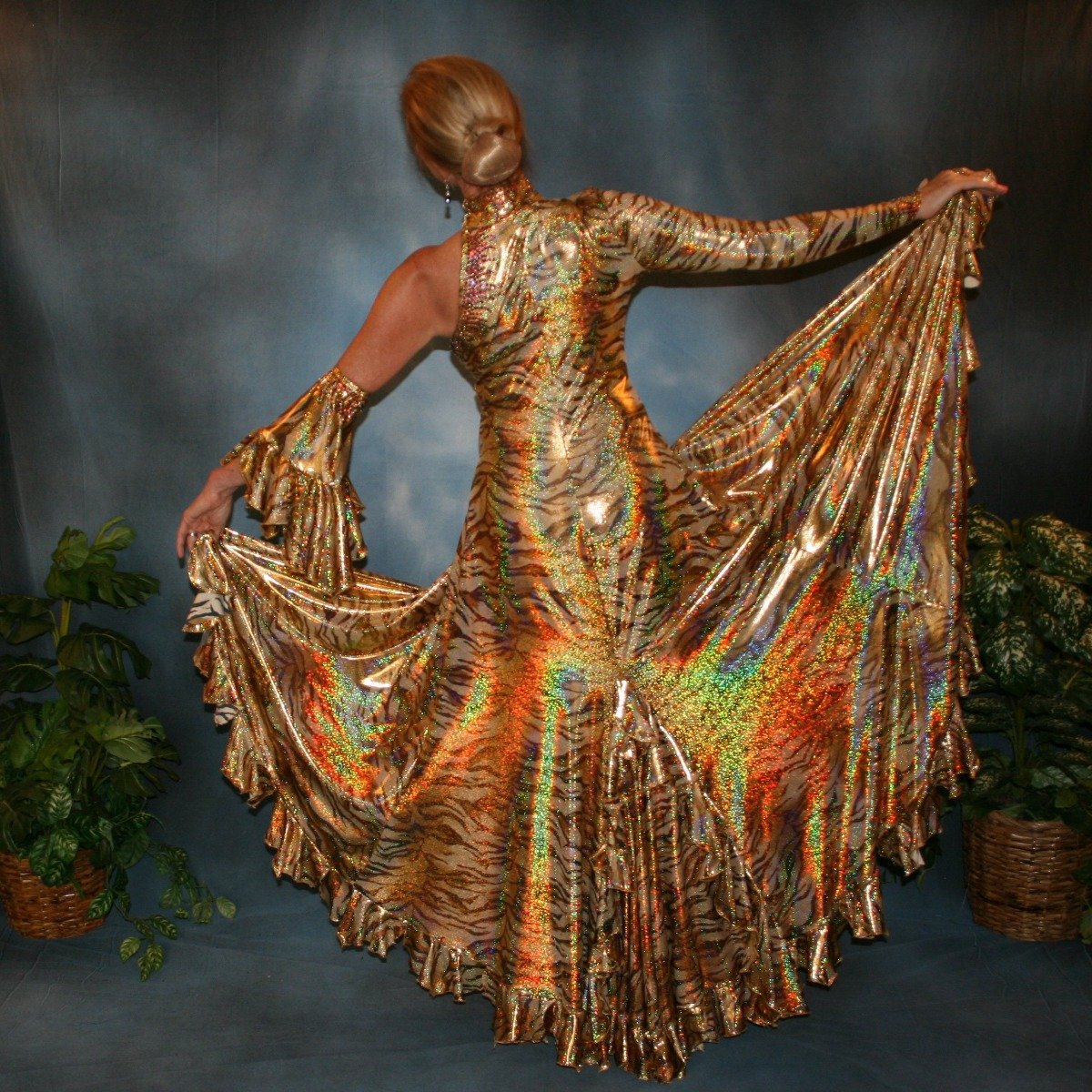 Crystal's Creations back view of gold tango/paso doble dress created of gold hologram tiger print lycra with many flounces & volcano colored Swarovski rhinestone work size 5/6-9/10
