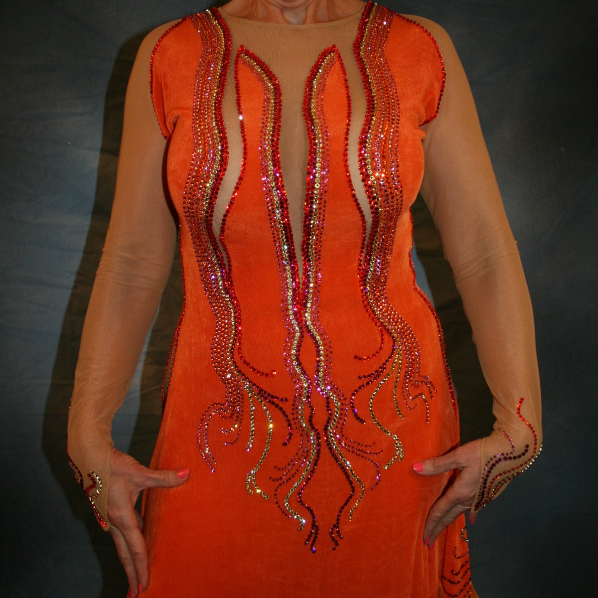 Crystal's Creations close up view of Sunny orange ballroom dress created in luxurious solid slinky with gorgeous printed chiffon in bursts of orange, pink & yellow, is embellished with Swarovski rhinestone work of orange hyacynth, rose, jonquil & fuschia.