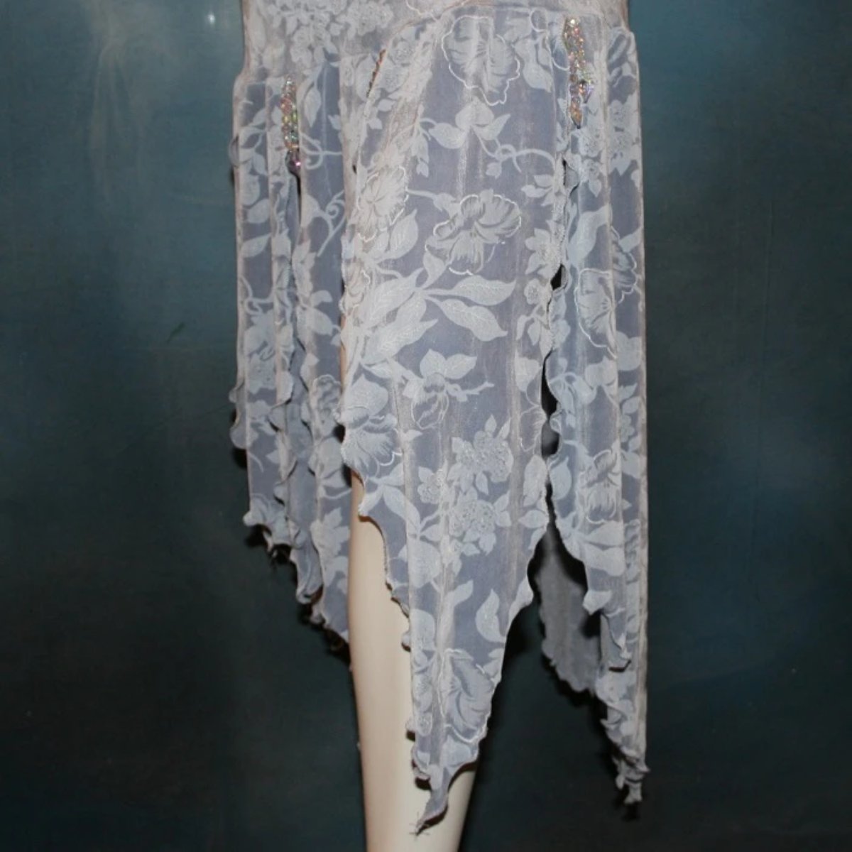 lower view of Violet social Latin/rhythm dress of light violet print slinky, enhanced with a touch of hand beading between skirt petals & sleeve edges, plus matching choker with silk flower, is lovely for any ballroom dance or special occasion.